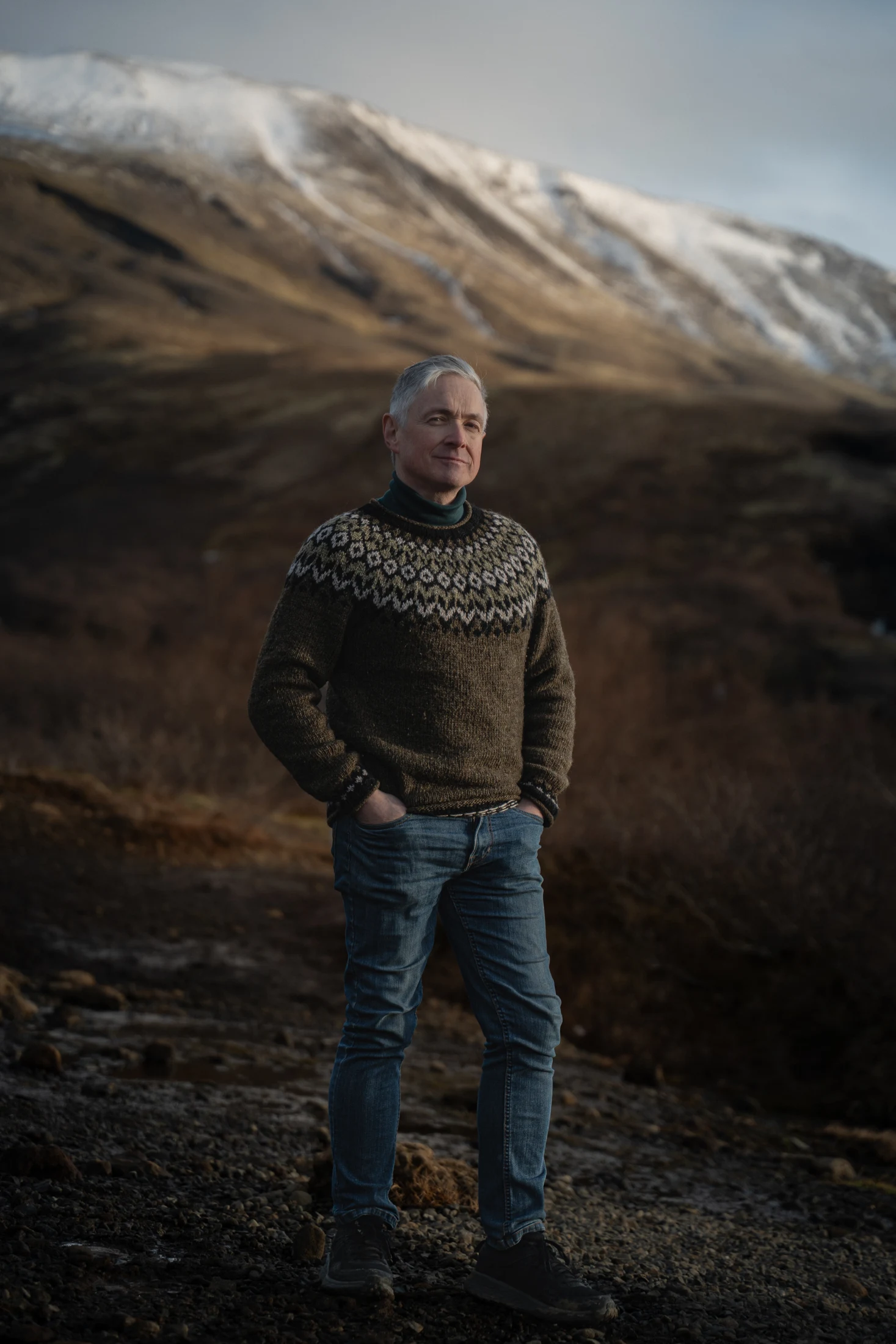 Michael McGlynn standing in a mountain landscape.