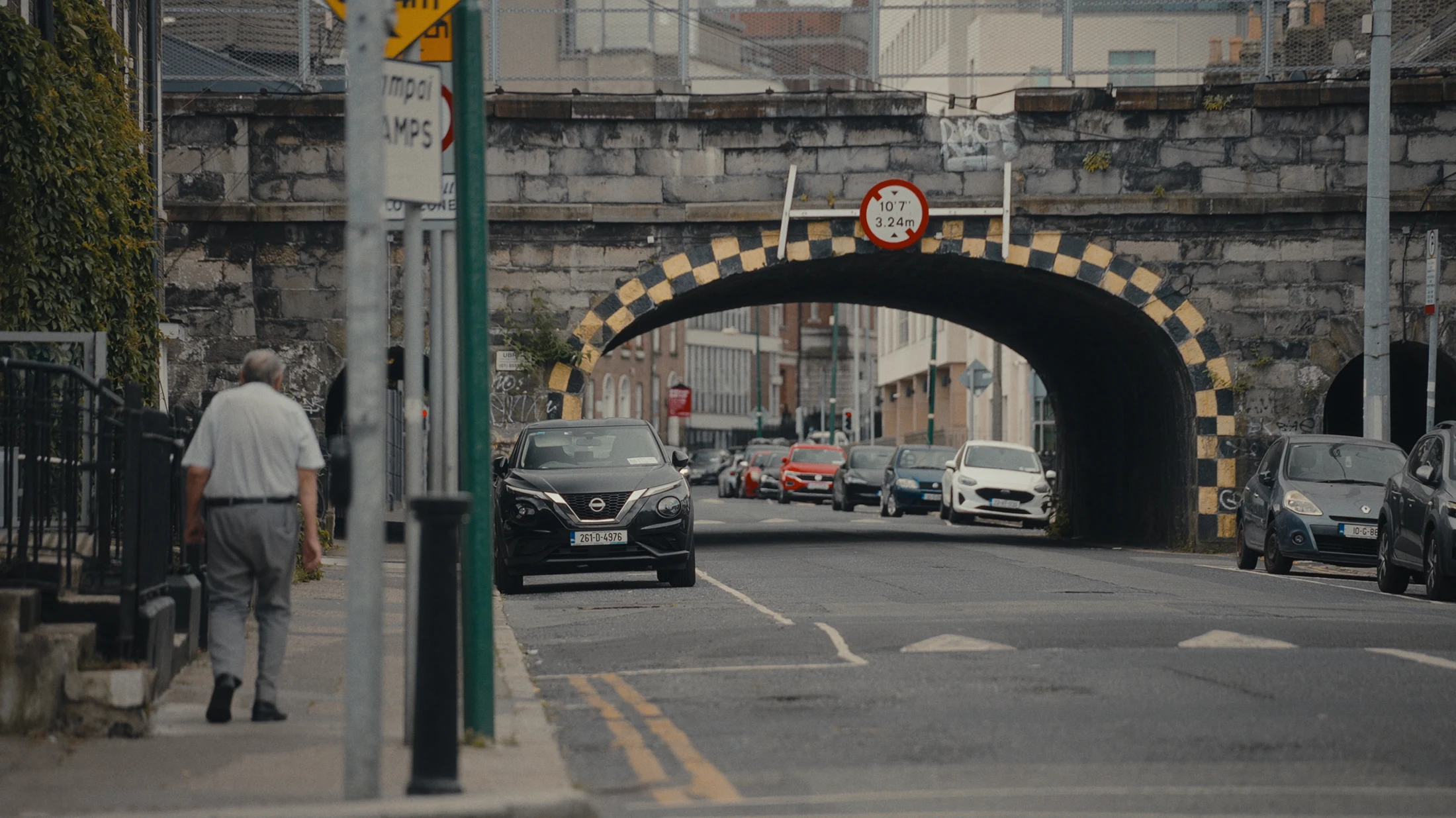 A quiet Dublin street beneath a railway bridge, from the film.